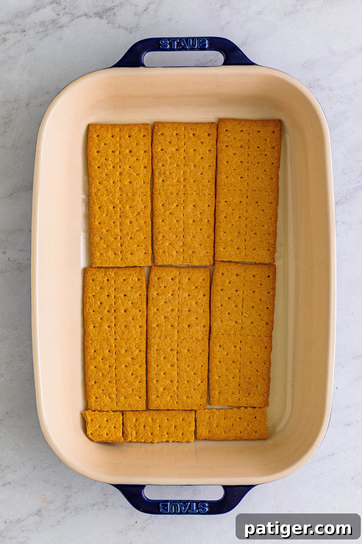 Whole graham crackers laid in an even layer in bottom of 9 x 13 baking pan.