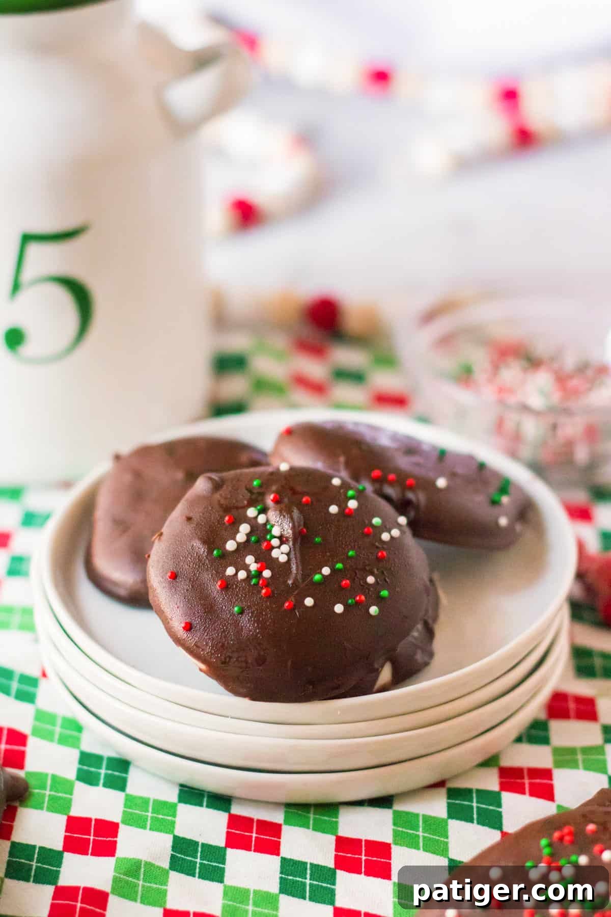 Vibrant homemade peppermint patties adorned with red, green, and white sprinkles, arranged artfully on a serving dish.