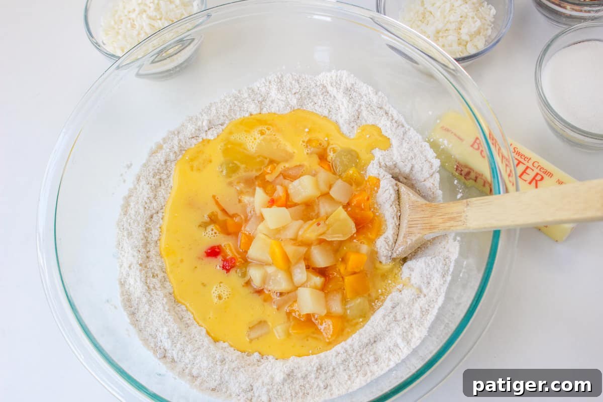 Fruit cocktail added to mixing bowl.