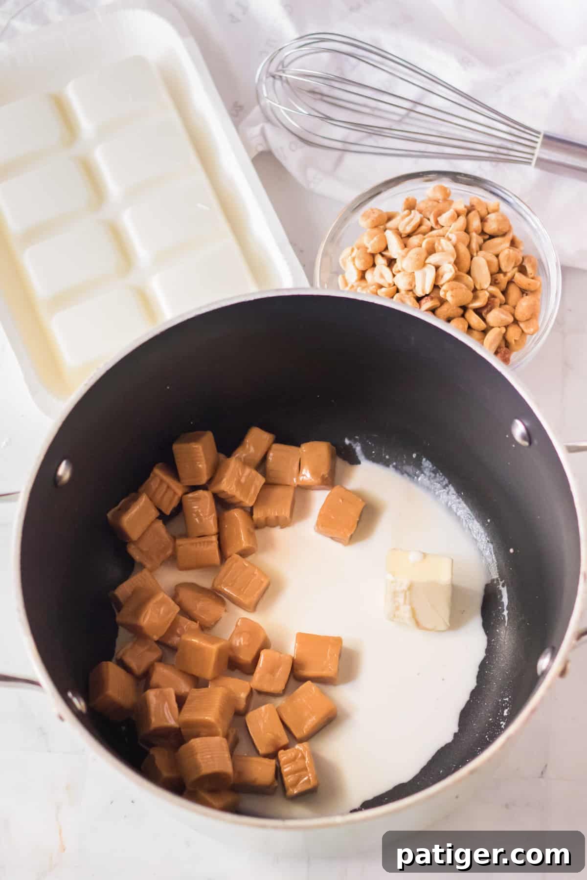 Unwrapped caramels, heavy cream, and butter melting in a saucepan over medium heat.