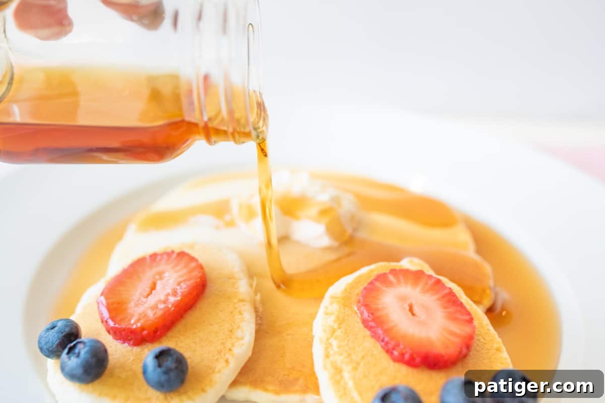 Cottontail Pancakes 6 Syrup being poured on Easter bunny pancakes.