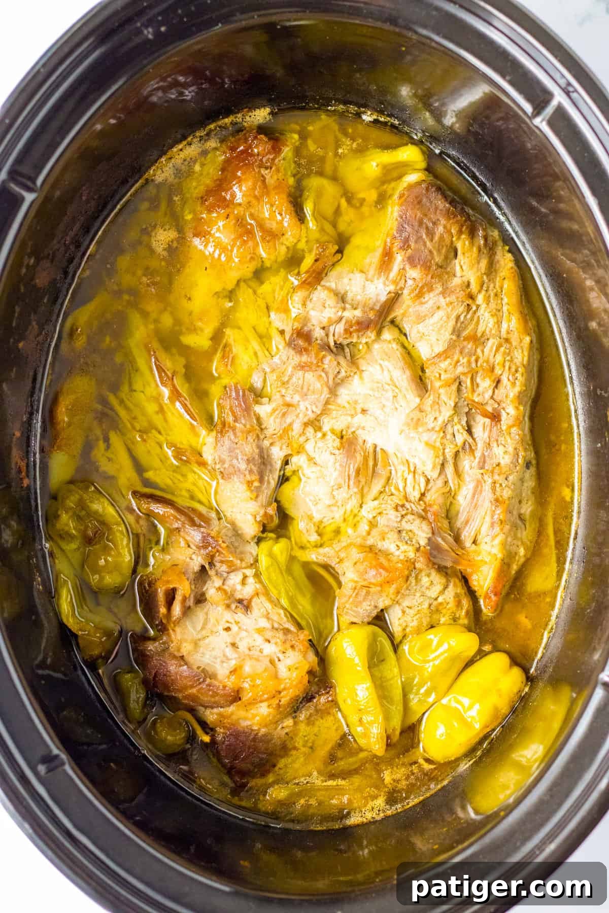 Slow cooked mississippi pork in crockpot, showing the tender, fall-apart meat.