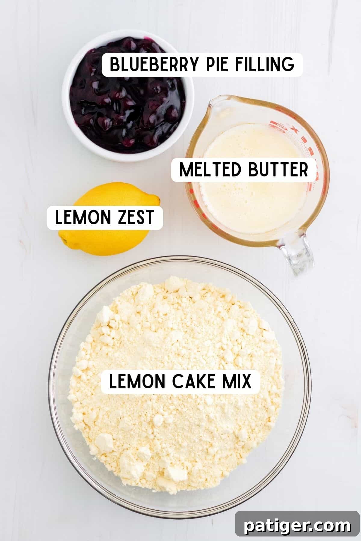 A fresh lemon and bowls containing blueberry pie filling, melted butter, and lemon cake mix – the four simple ingredients for the dump cake.