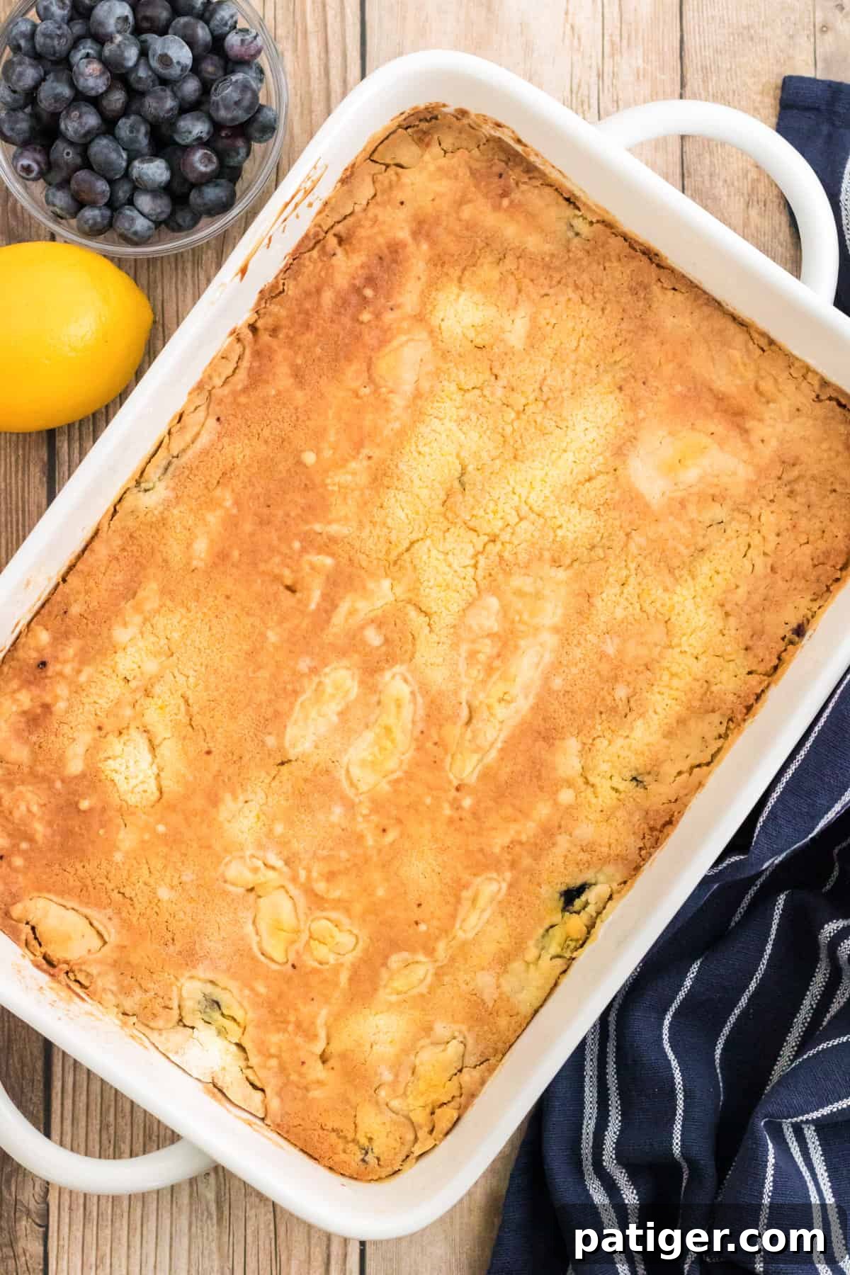 A golden brown dump cake, perfectly baked and just removed from the oven, showing its enticing crust.
