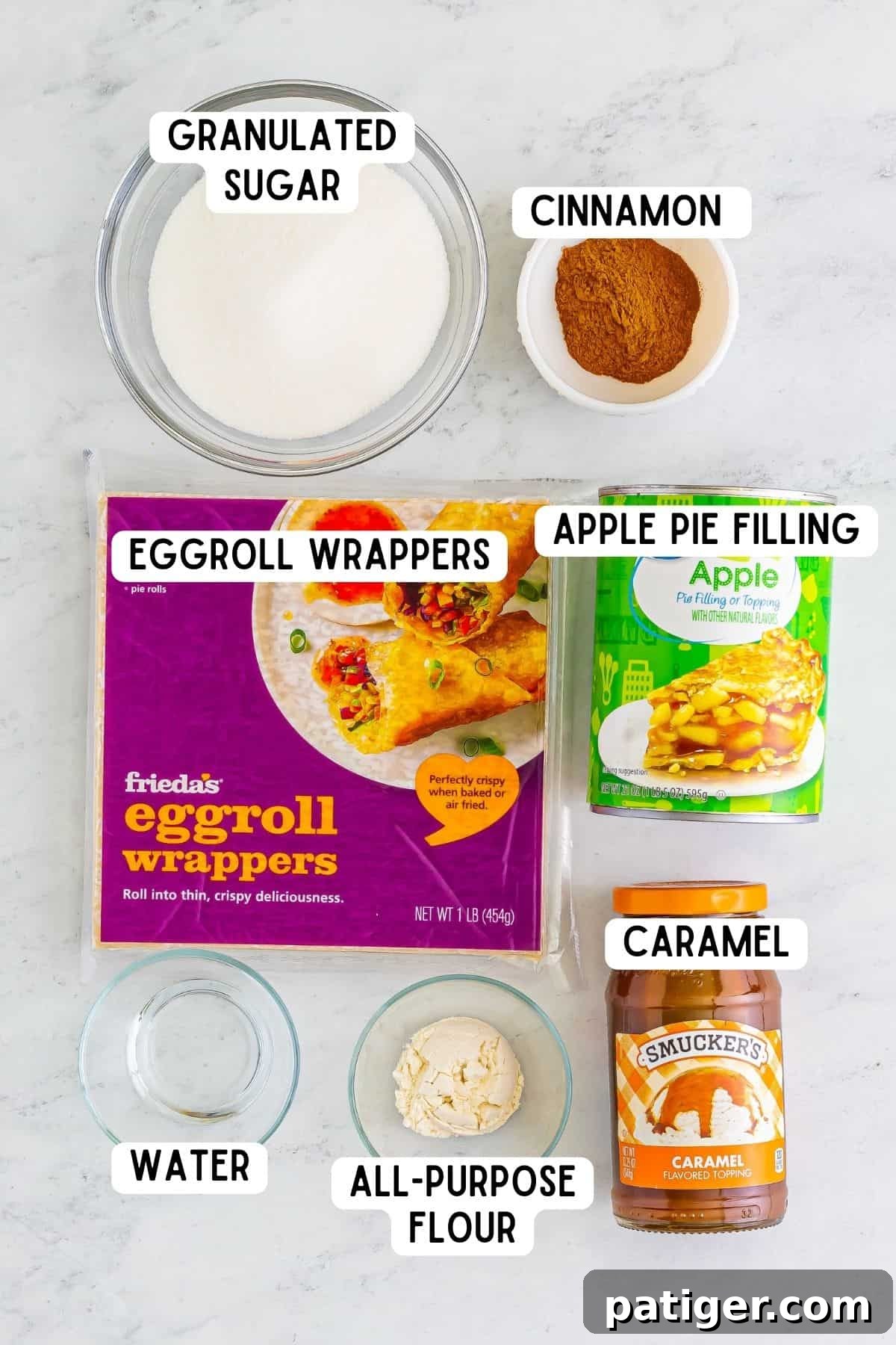 granulated sugar, ground cinnamon, water, flour, package of egg roll wrappers, can of apple pie filling, and jar of caramel.