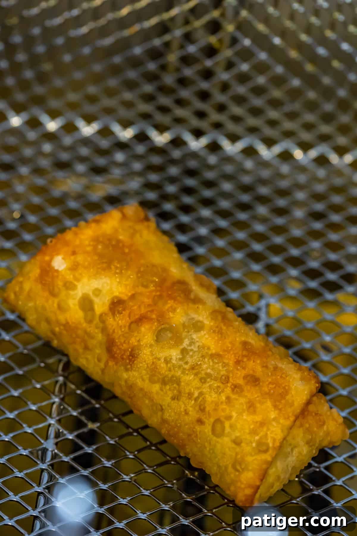 Egg roll in fryer basket.