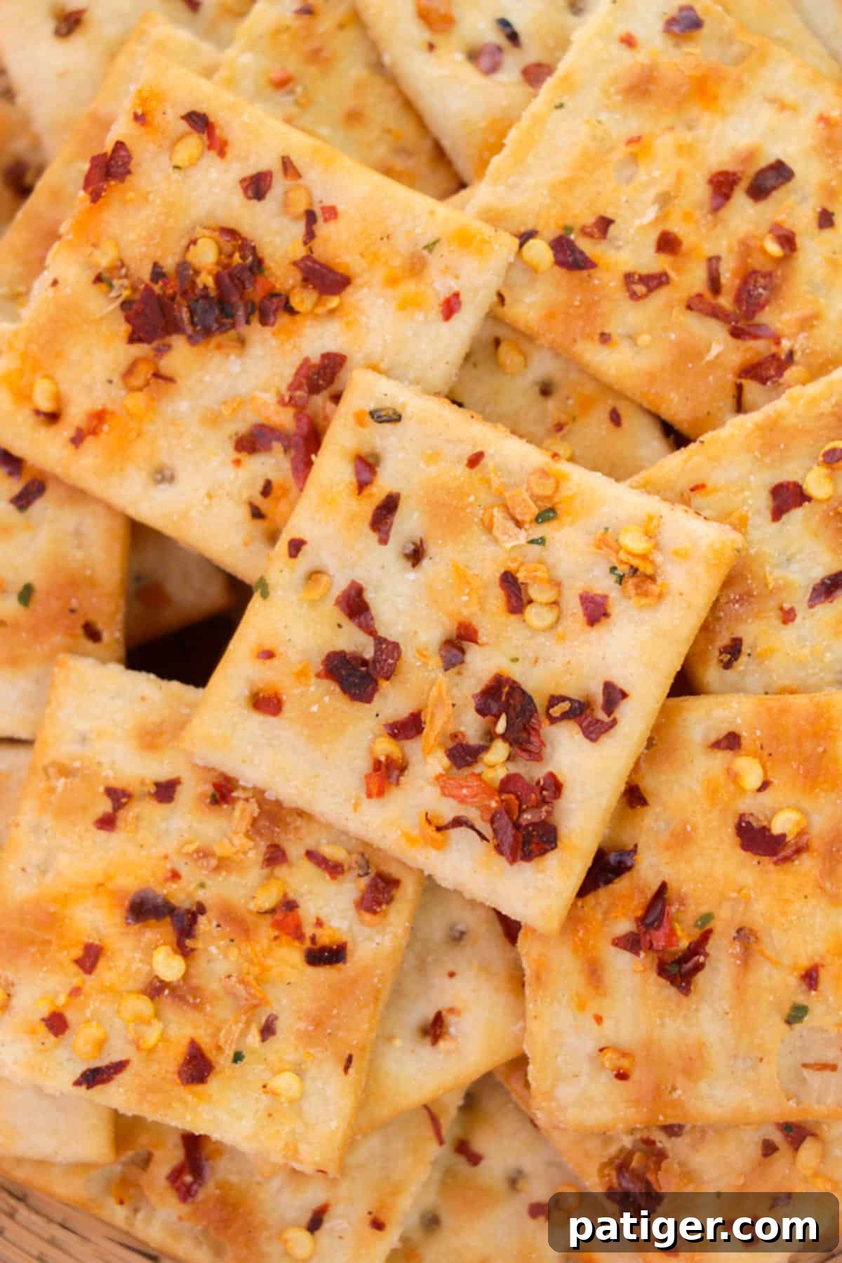 Close-up of saltine crackers with red pepper flakes, ready to be transformed into Alabama Fire Crackers.
