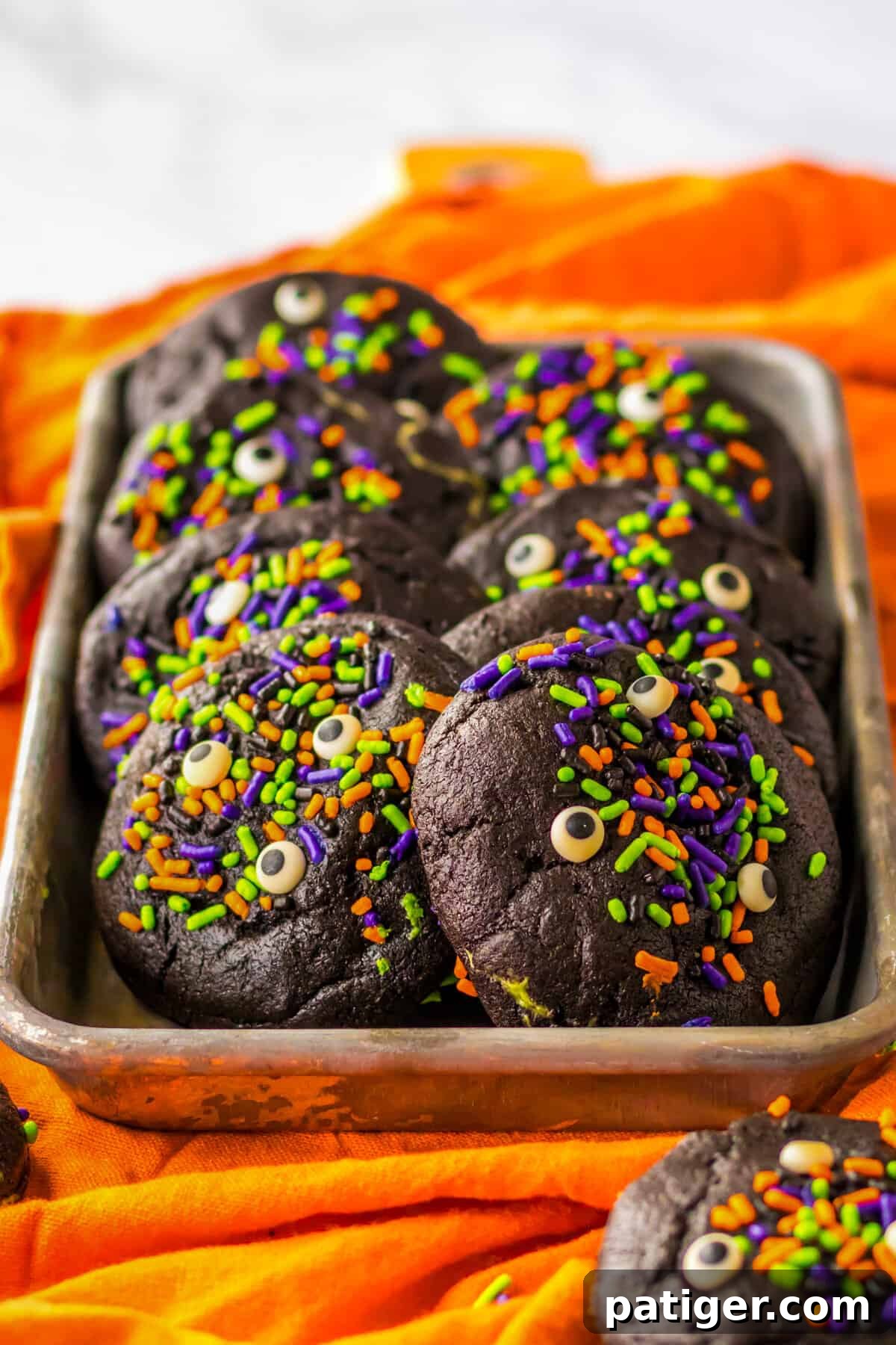 Tray of halloween cookies with sprinkles and candy eyes.