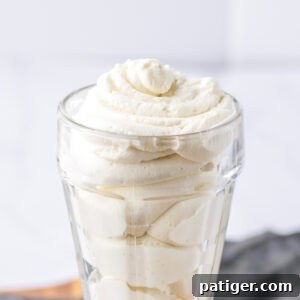 Light and creamy homemade stabilized whipped cream in a glass.