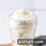Light and creamy homemade stabilized whipped cream in a glass.