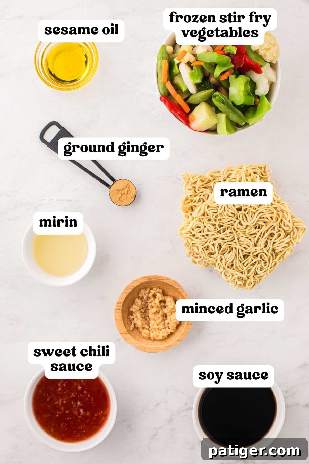 A curated selection of fresh and pantry ingredients laid out on a kitchen countertop, including a bag of frozen stir-fry vegetables, packages of ramen noodles, a jar of minced garlic, bottles of mirin, rich sesame oil, low-sodium soy sauce, and sweet chili sauce, along with ground ginger for an aromatic touch.