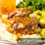 Slow Cooker Short Ribs served over mashed potatoes and topped with brown gravy.