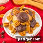 Homemade pecan turtle candy piled on a plate, combining pecans, caramel, and chocolate for a classic dessert.