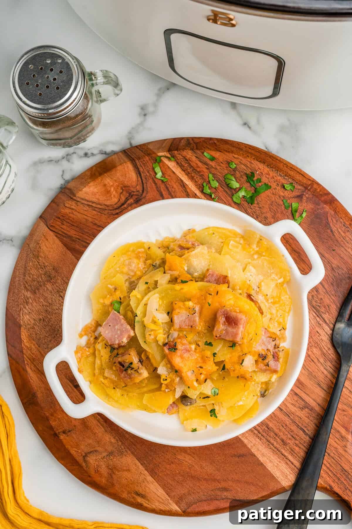 A plated serving of scalloped potatoes with ham.
