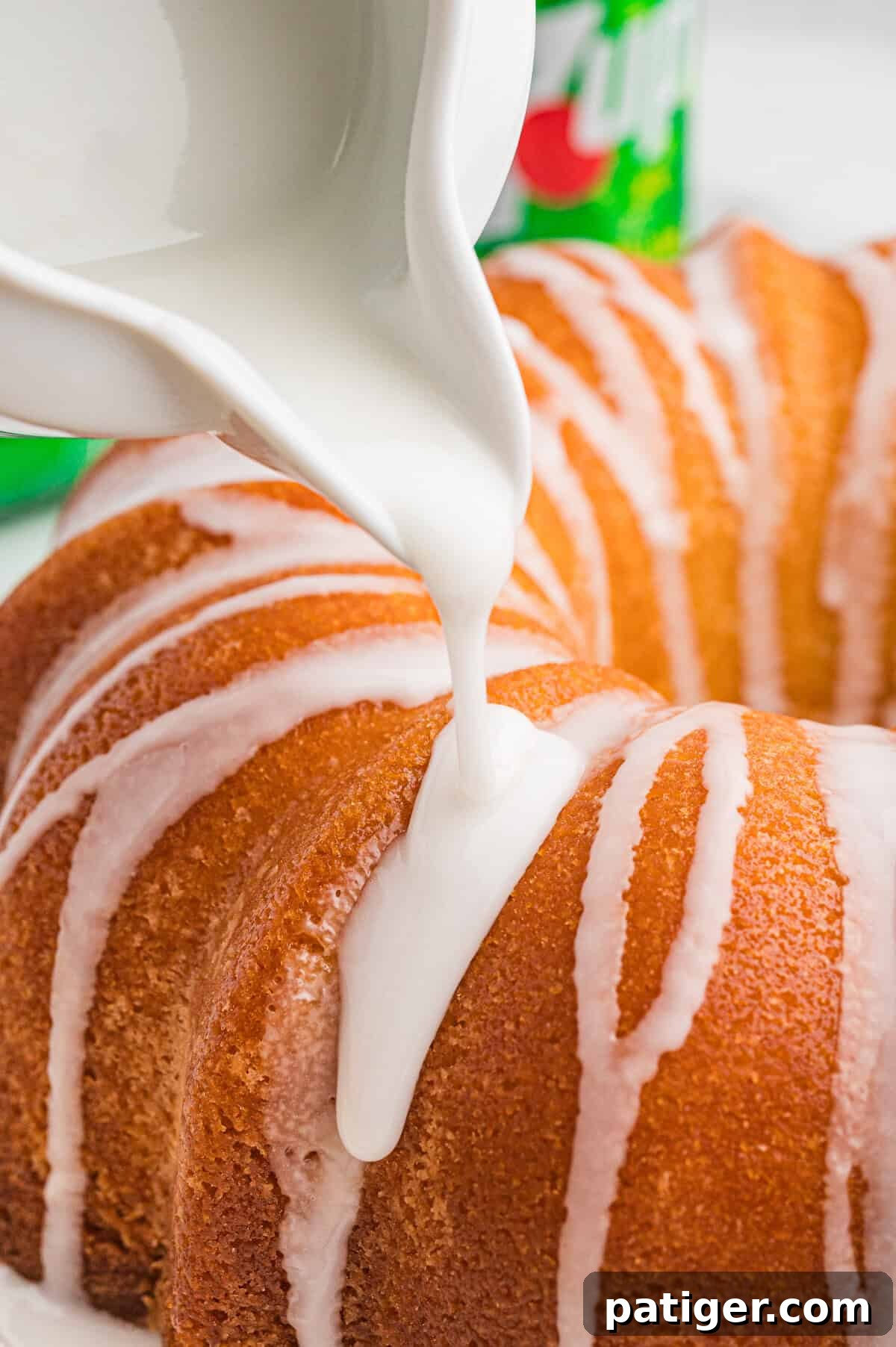 Glaze being drizzled over 7 up cake.
