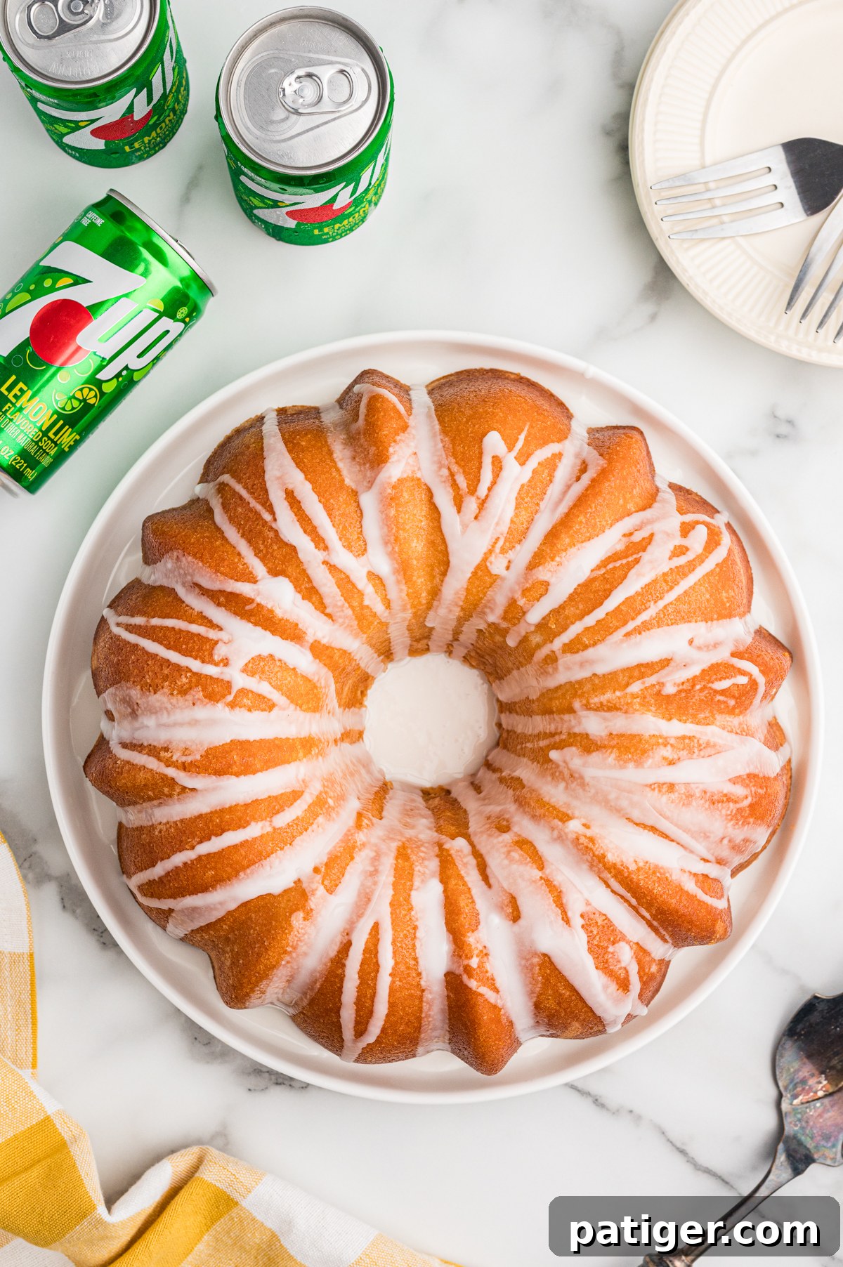 Overhead view of a golden brown 7 Up pound cake with white glaze drizzled over the top.