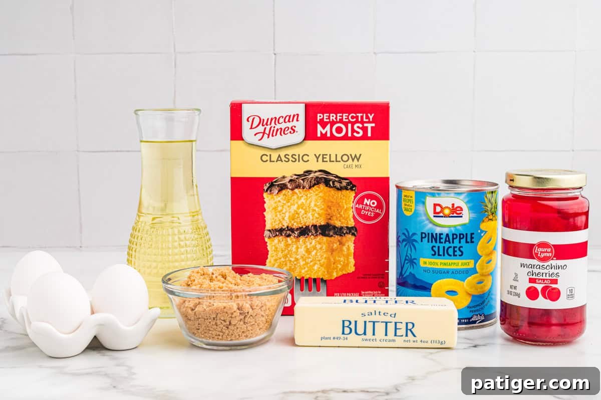 Ingredients for pineapple upside down cake: yellow cake mix, canned pineapple slices, maraschino cherries, butter, brown sugar, and eggs.