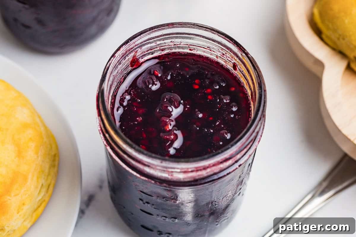 Homemade blackberry jam in a glass mason jar.