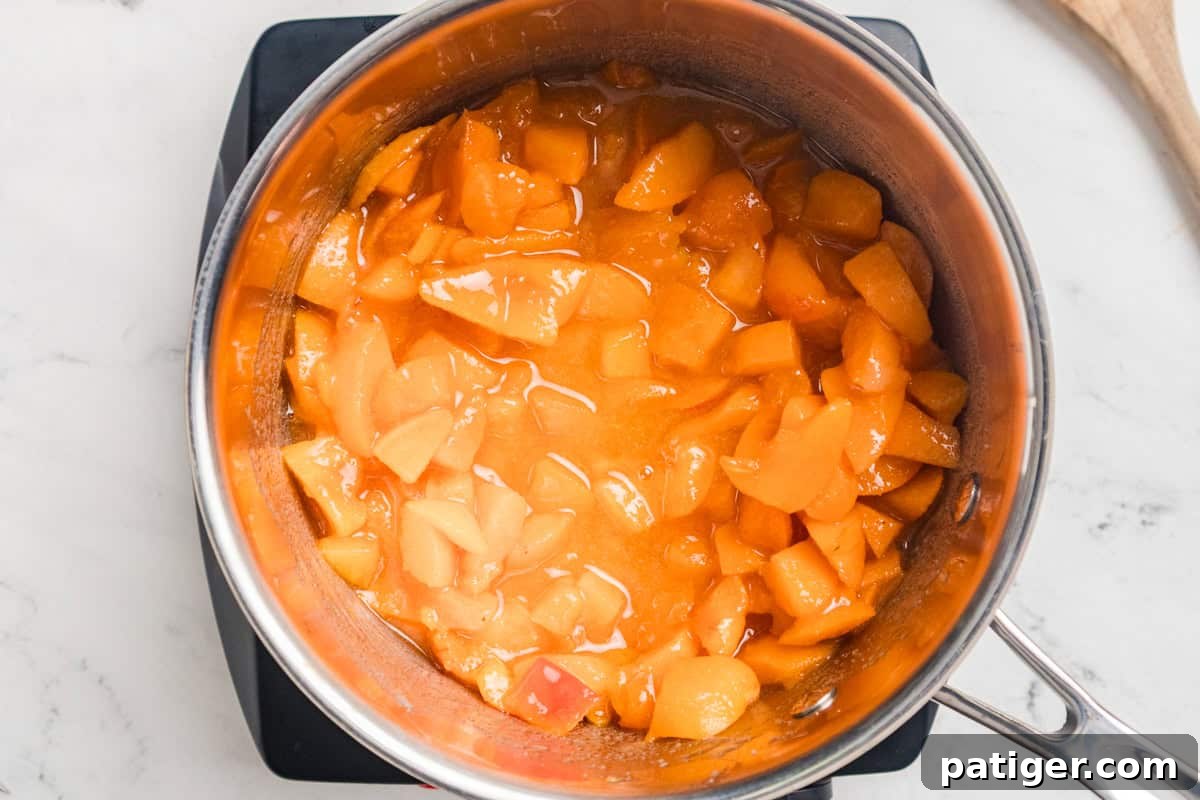Apricot Jam Without Pectin: Simple Homemade Recipe 6 Apricot jam cooking in a saucepan.