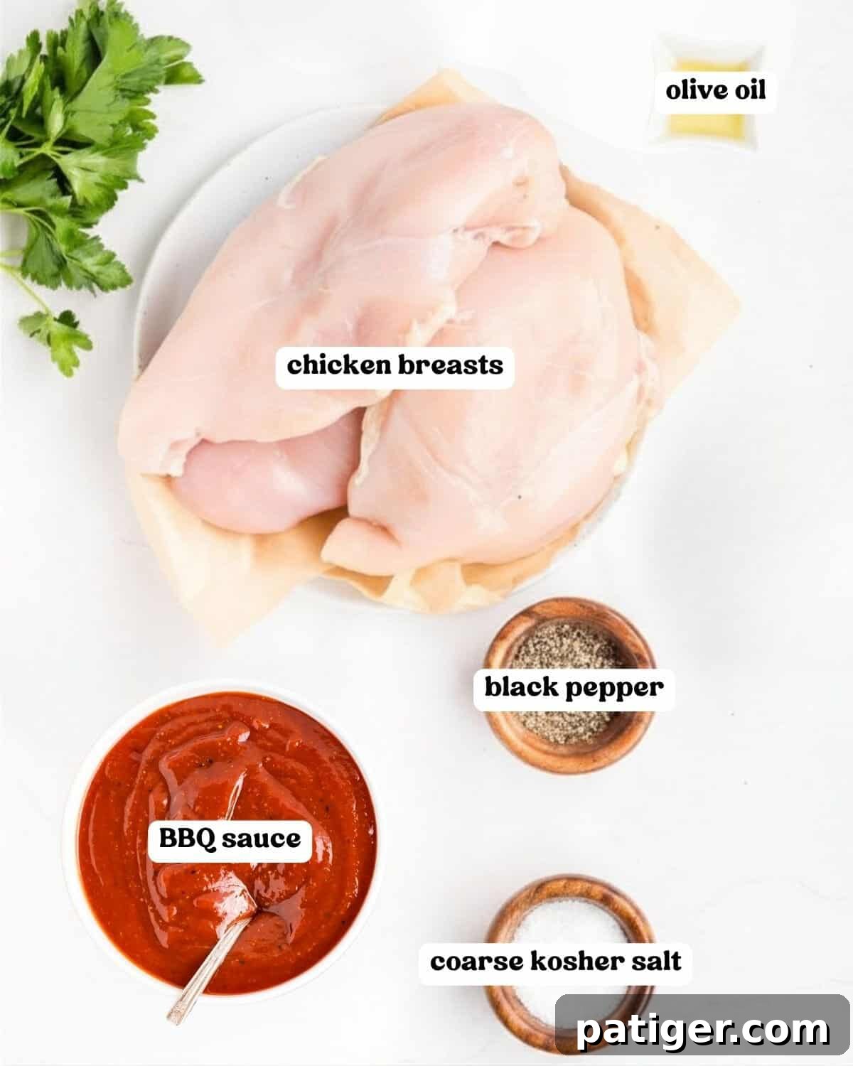 Oven-Baked BBQ Chicken Breasts with Sticky Glaze 4 Labeled ingredients on a white counter: chicken breasts, olive oil, BBQ sauce, black pepper, coarse salt, and parsley.
