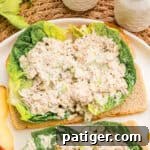 Tuna Salad Recipe for Sandwiches, Wraps, and Lunch 7 Open-faced tuna salad piled on lettuce and toasted bread with apple slices on the side.