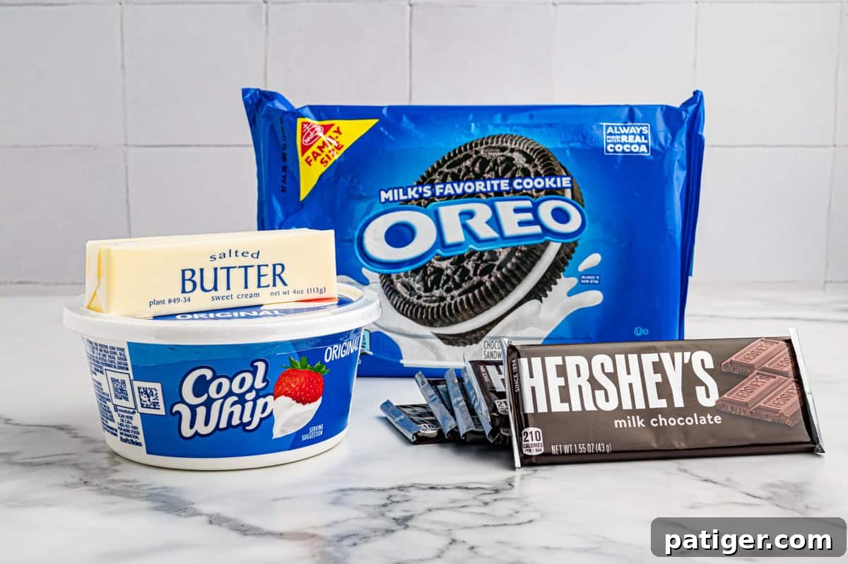 Homemade Hershey's Chocolate Pie Recipe 4 Ingredients on a marble counter: Oreo cookies, salted butter, a tub of Cool Whip, and Hershey's milk chocolate bars.