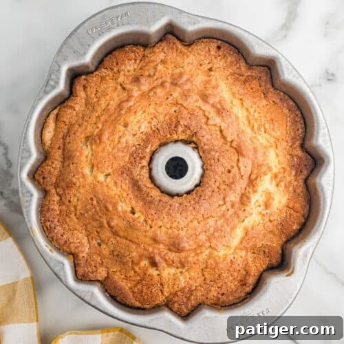 Moist Pumpkin Bundt Cake Made with Cake Mix 5 Golden brown Bundt cake in a fluted metal pan.