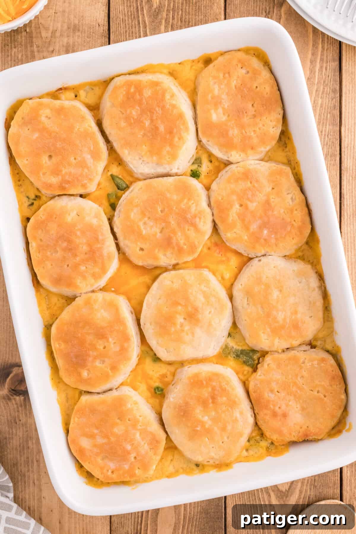 One-Pan Chicken Pot Pie Casserole with Biscuits 7 Chicken pot pie casserole with biscuits baked in a white rectangular dish.
