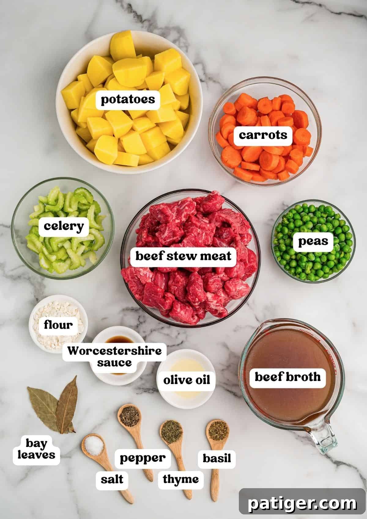 Classic Hearty Beef Stew Recipe with Tender Braised Beef 3 Beef stew meat, potatoes, carrots, celery, and peas in bowls on marble, with flour, olive oil, Worcestershire sauce, broth, and dried spices.